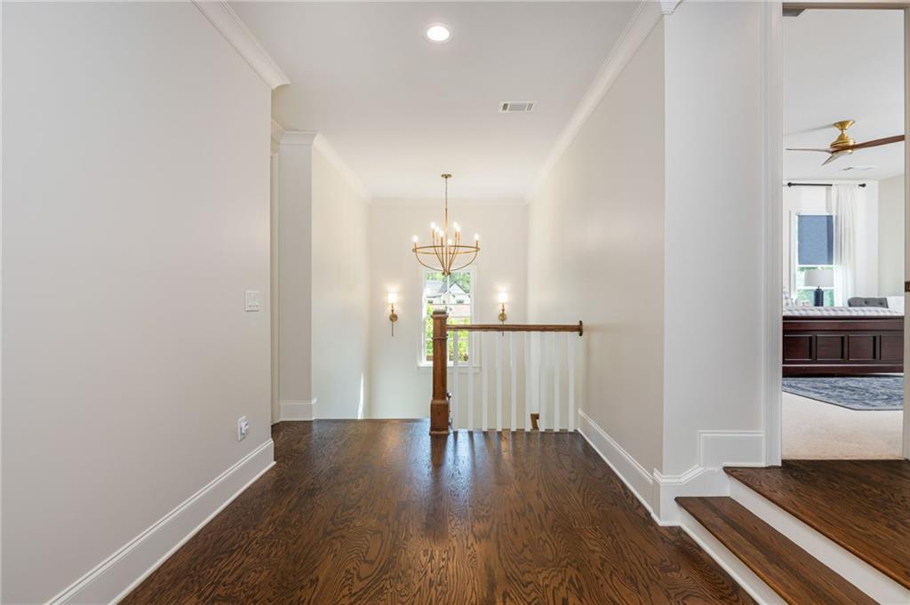 4184 Thompson Mill Road Buford, GA 30519 - Photo 31 of 53 a view of a hallway with wooden floor and staircase