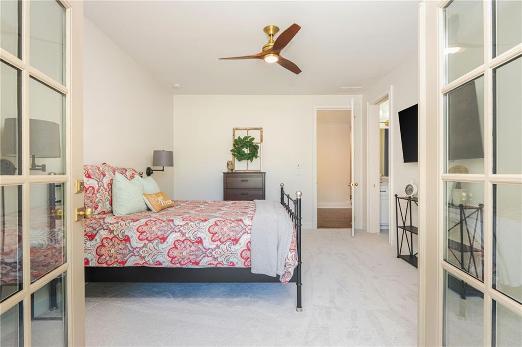 4184 Thompson Mill Road Buford, GA 30519 - Photo 33 of 53 a bedroom with a bed and a ceiling fan