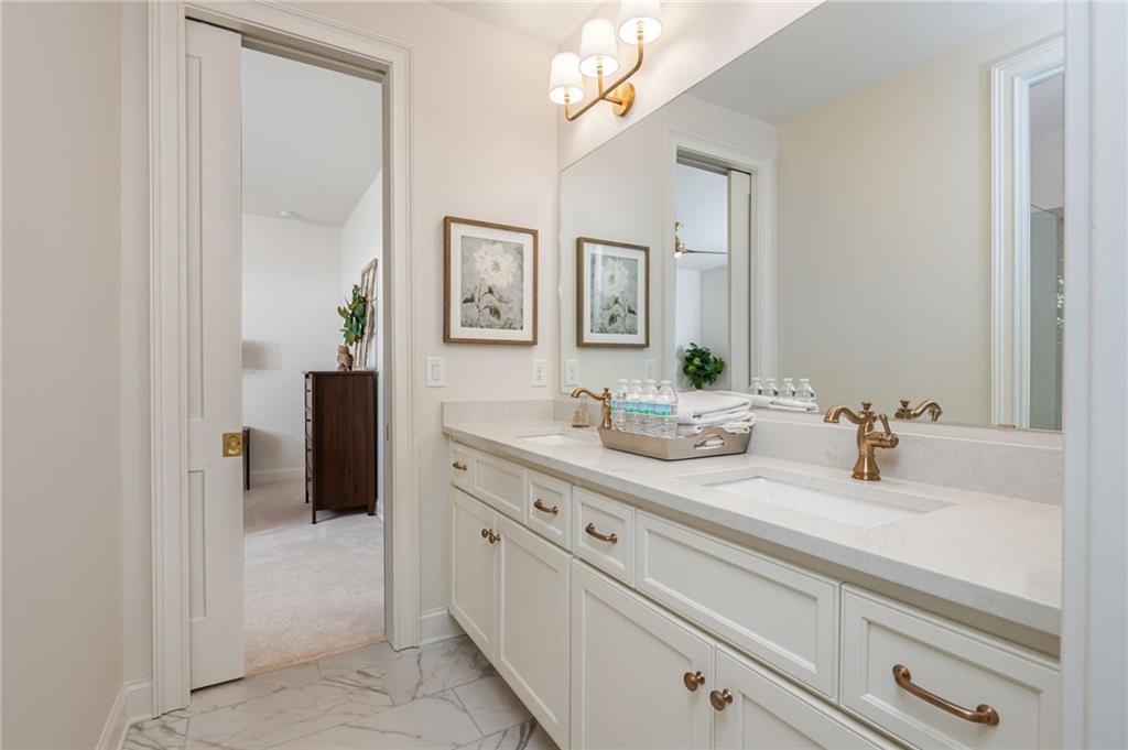 4184 Thompson Mill Road Buford, GA 30519 - Photo 35 of 53 a bathroom with a sink and a mirror