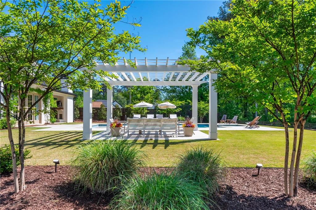 4184 Thompson Mill Road Buford, GA 30519 - Photo 45 of 53 a view of a swimming pool with chair and tables