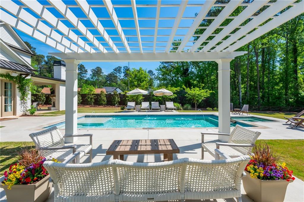 4184 Thompson Mill Road Buford, GA 30519 - Photo 46 of 53 a view of a patio with a dining table and chairs with wooden floor and fence