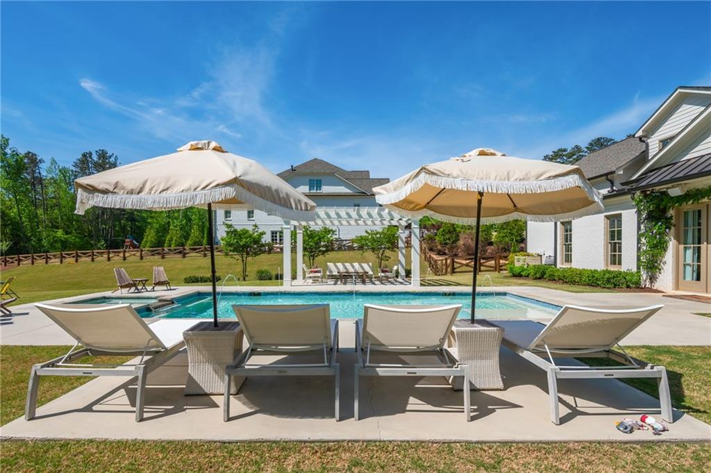 4184 Thompson Mill Road Buford, GA 30519 - Photo 49 of 53 a view of a patio with a dining table and chairs under an umbrella