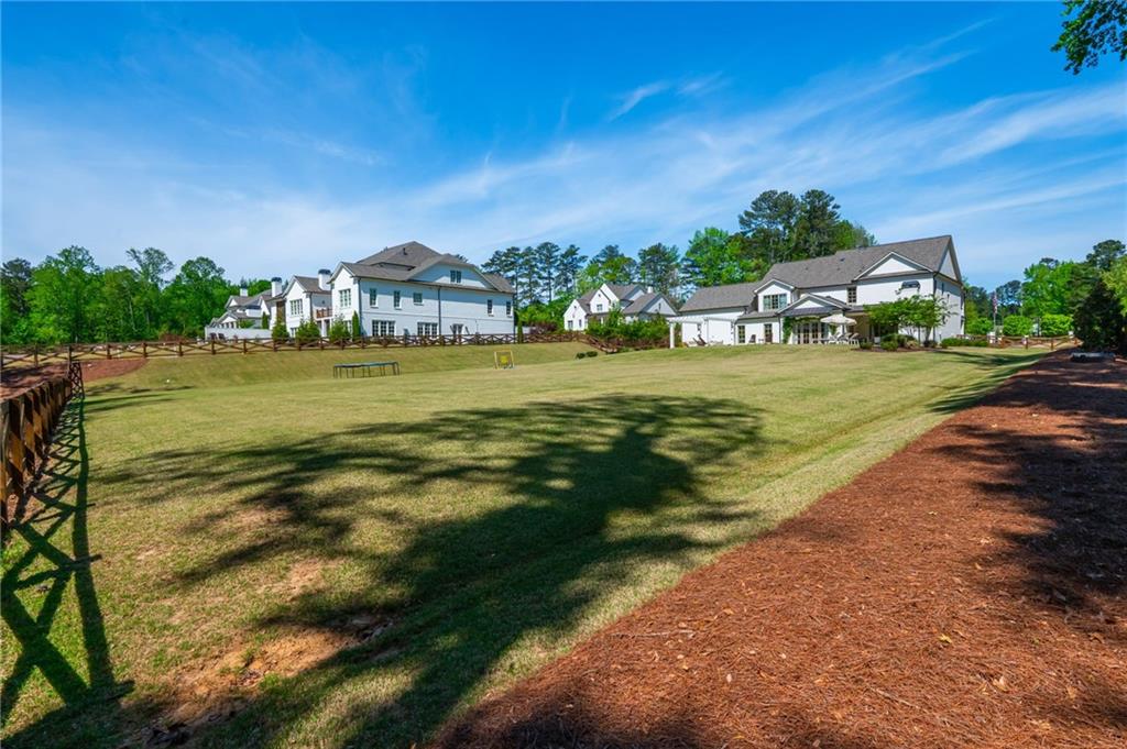 4184 Thompson Mill Road Buford, GA 30519 - Photo 6 of 53 a view of a lake with a big yard