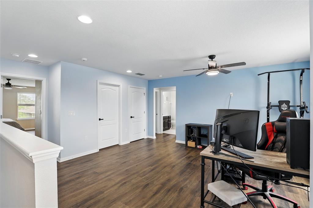 1338 Riley Circle Deland, FL 32724 - Photo 14 of 39 a view of a workspace with furniture and wooden floor