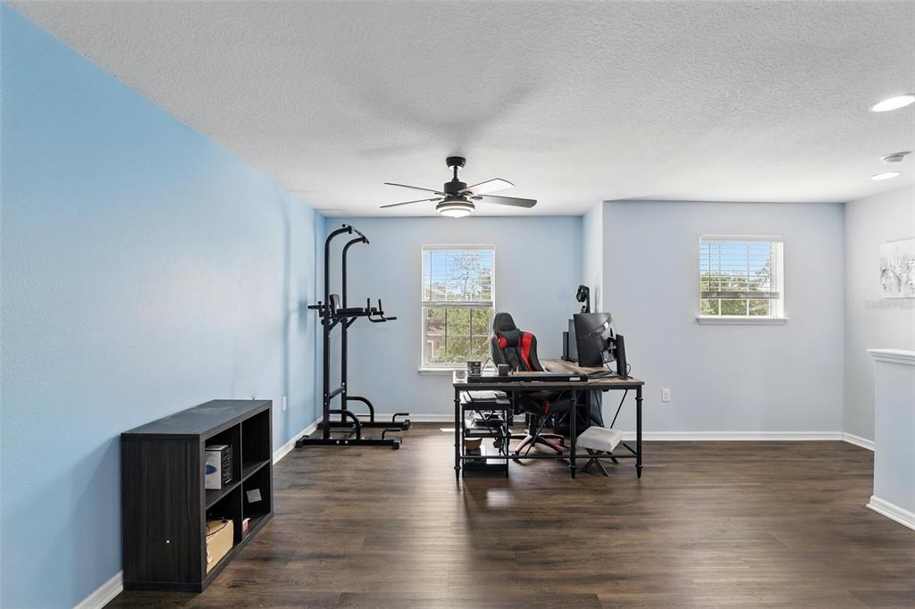 1338 Riley Circle Deland, FL 32724 - Photo 15 of 39 a view of a workspace with furniture wooden floor and a chandelier