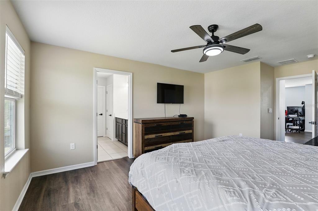 1338 Riley Circle Deland, FL 32724 - Photo 17 of 39 a bedroom with a bed and a flat screen tv