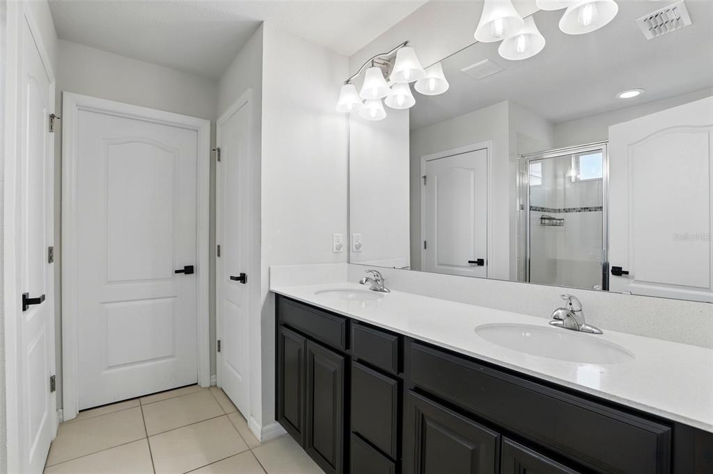 1338 Riley Circle Deland, FL 32724 - Photo 18 of 39 a bathroom with a double vanity sink and a mirror