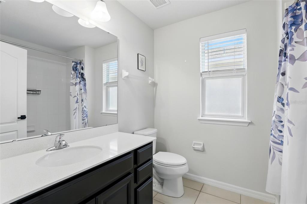 1338 Riley Circle Deland, FL 32724 - Photo 23 of 39 a bathroom with a double vanity sink toilet and a mirror