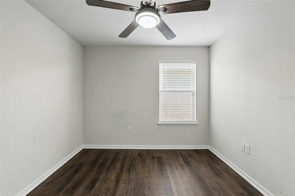 1338 Riley Circle Deland, FL 32724 - Photo 25 of 39 an empty room with a window and wooden floor