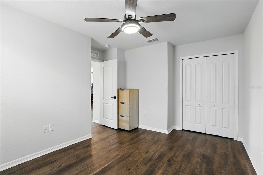 1338 Riley Circle Deland, FL 32724 - Photo 26 of 39 a view of an empty room with wooden floor