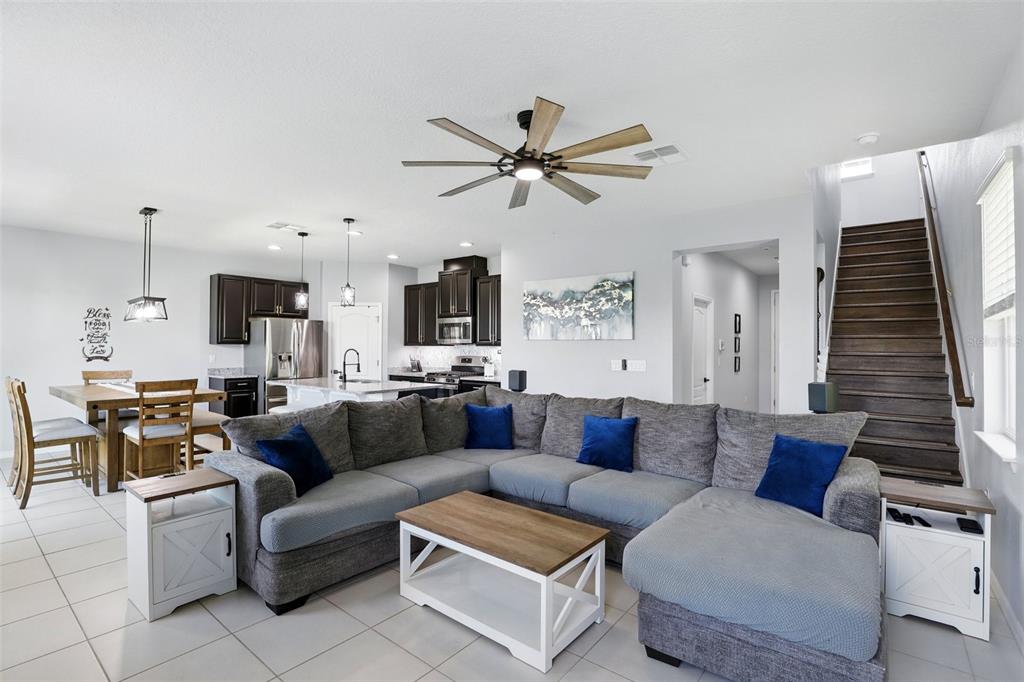 1338 Riley Circle Deland, FL 32724 - Photo 4 of 39 a living room with furniture a ceiling fan and a rug