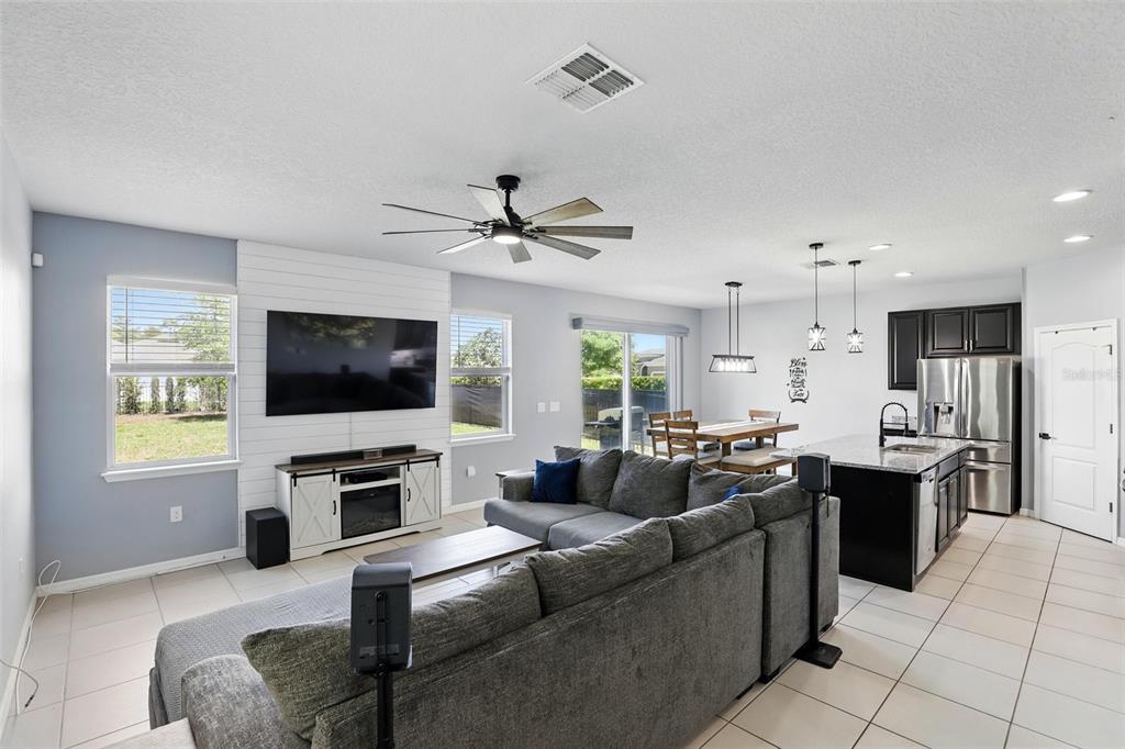 1338 Riley Circle Deland, FL 32724 - Photo 5 of 39 a living room with furniture a flat screen tv and a window