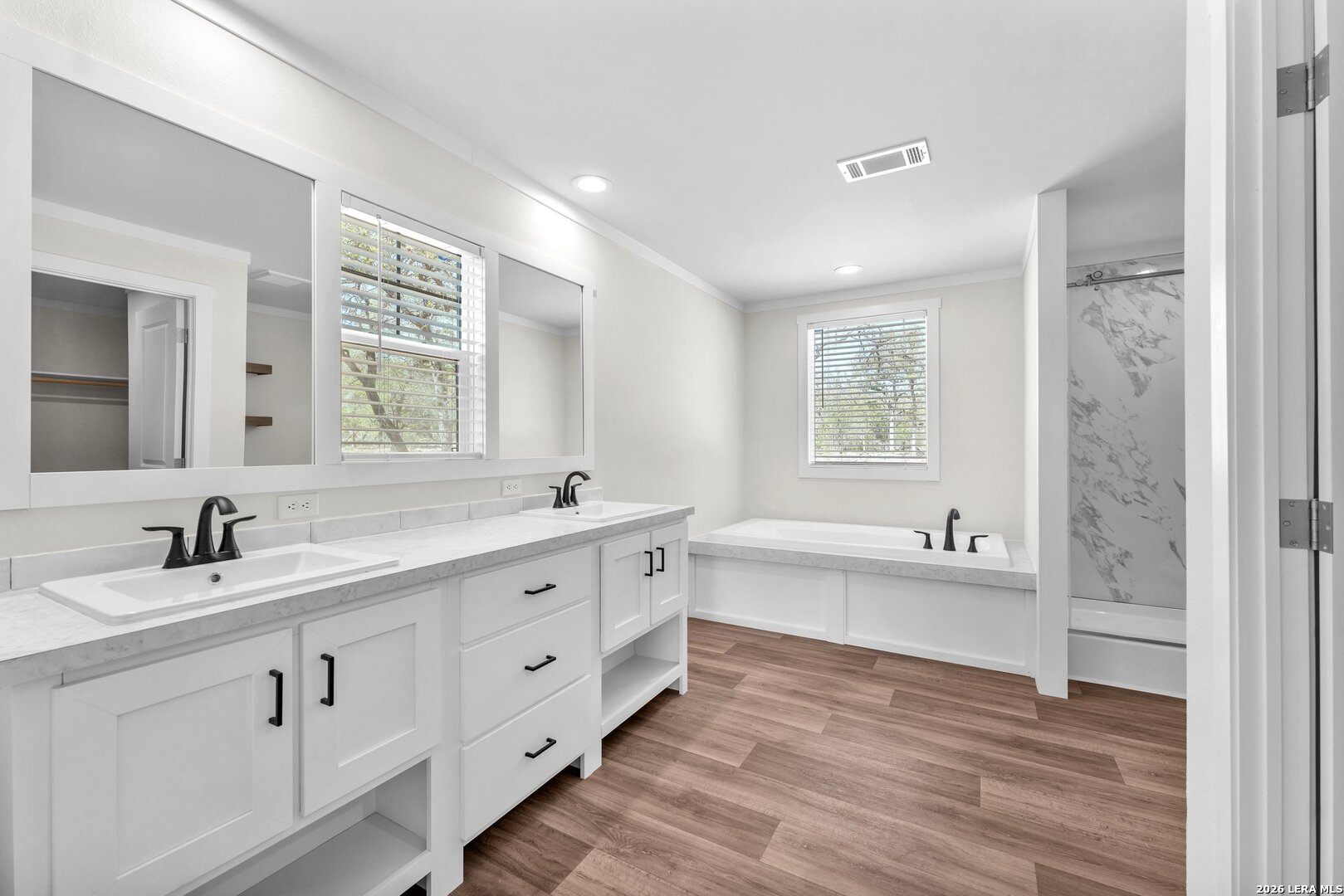2218 Stevens Road Somerset, TX 78069 - Photo 11 of 24 a bathroom with a granite countertop sink mirror bathtub and double