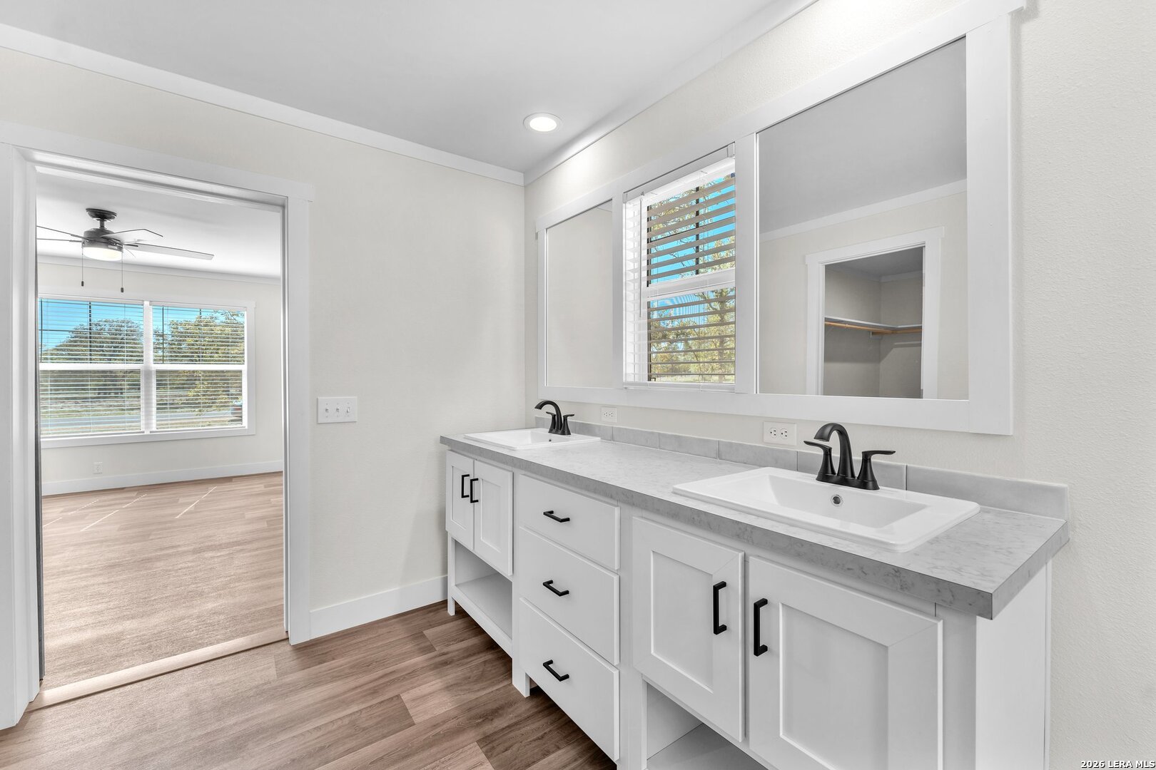 2218 Stevens Road Somerset, TX 78069 - Photo 12 of 24 a bathroom with a double vanity sink and mirror