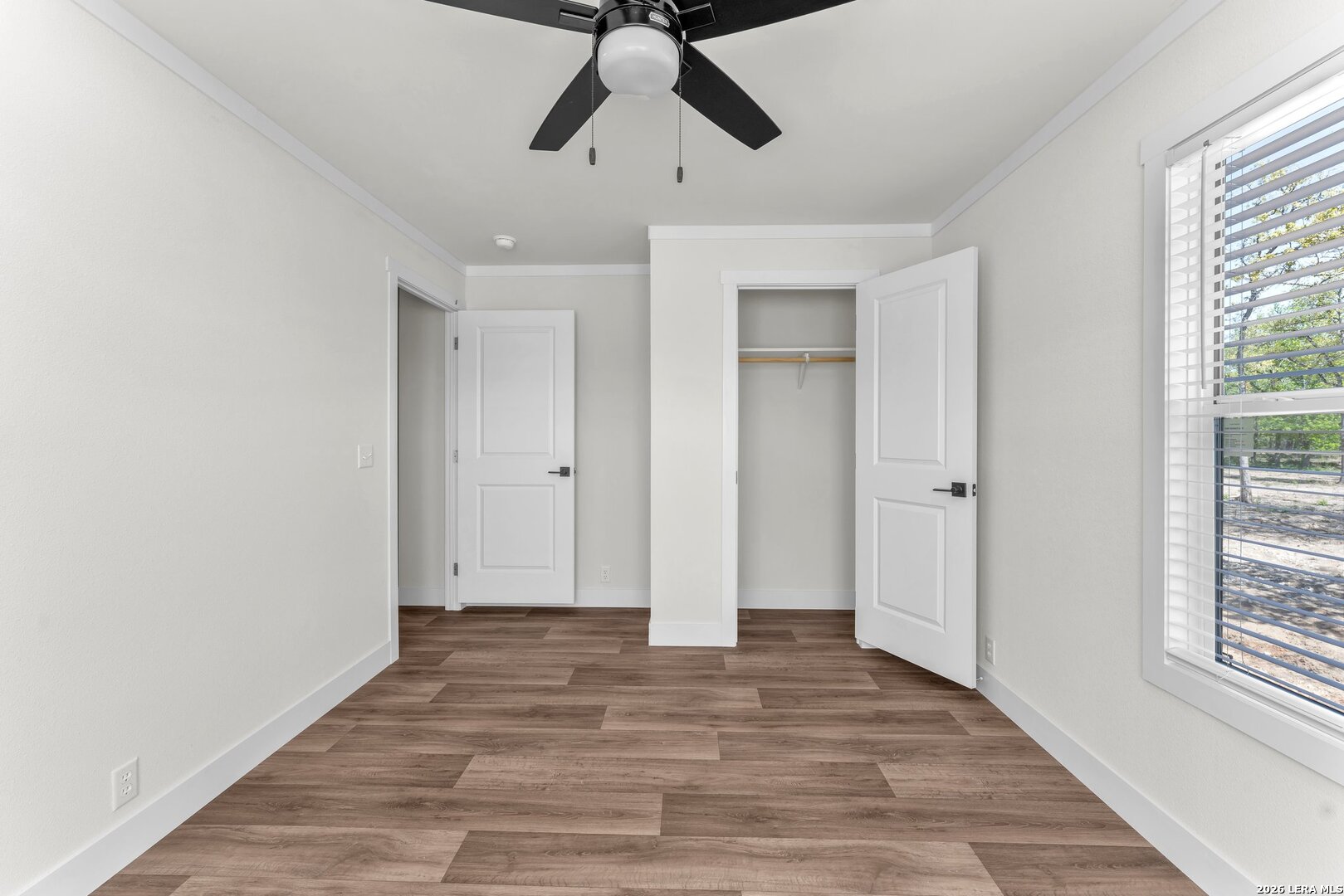 2218 Stevens Road Somerset, TX 78069 - Photo 14 of 24 a view of empty room with wooden floor and window