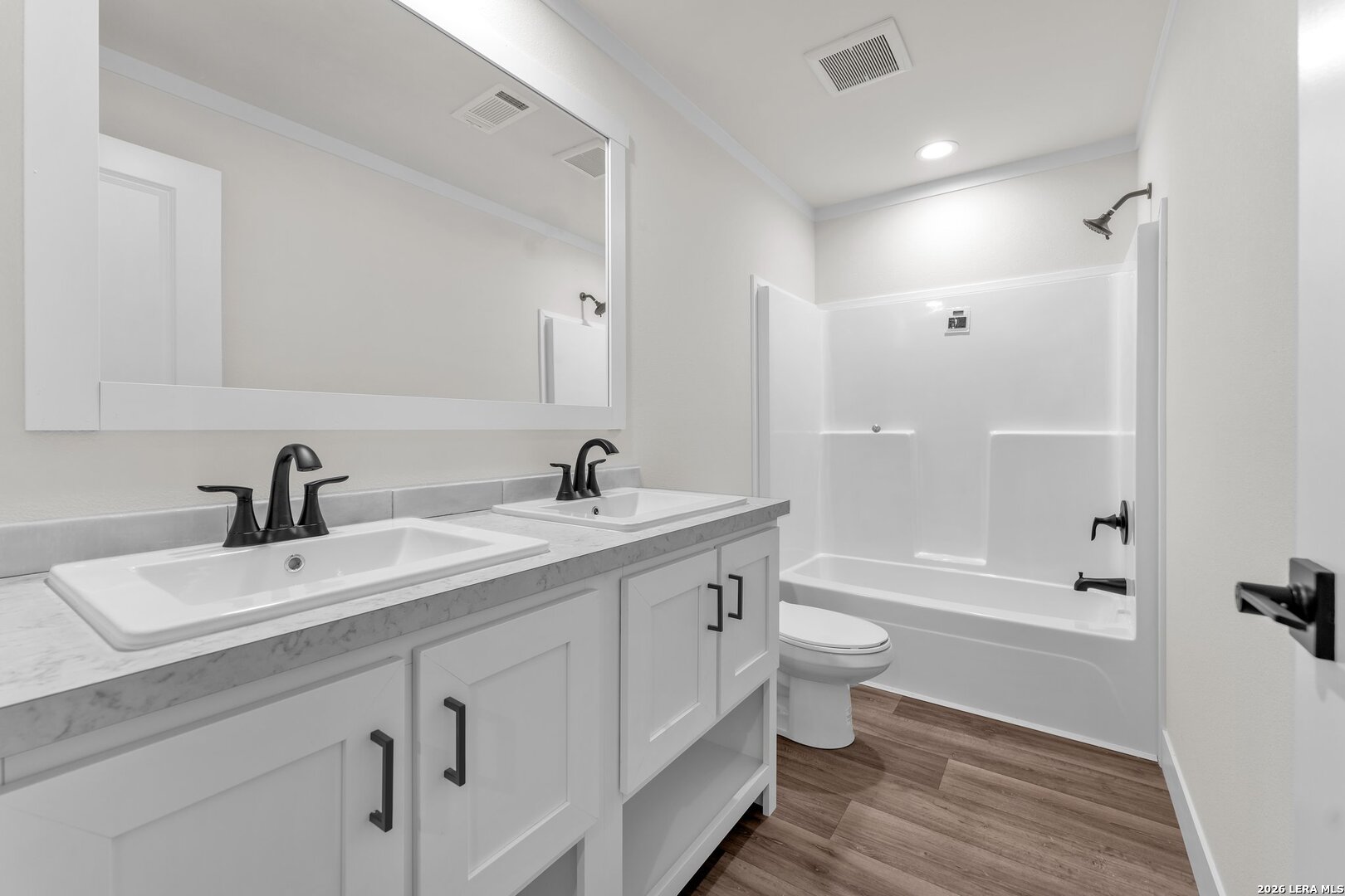 2218 Stevens Road Somerset, TX 78069 - Photo 15 of 24 a bathroom with a double vanity sink toilet and shower
