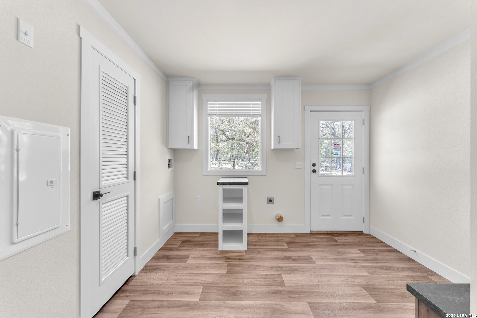 2218 Stevens Road Somerset, TX 78069 - Photo 16 of 24 a view of a kitchen with wooden floor and a window