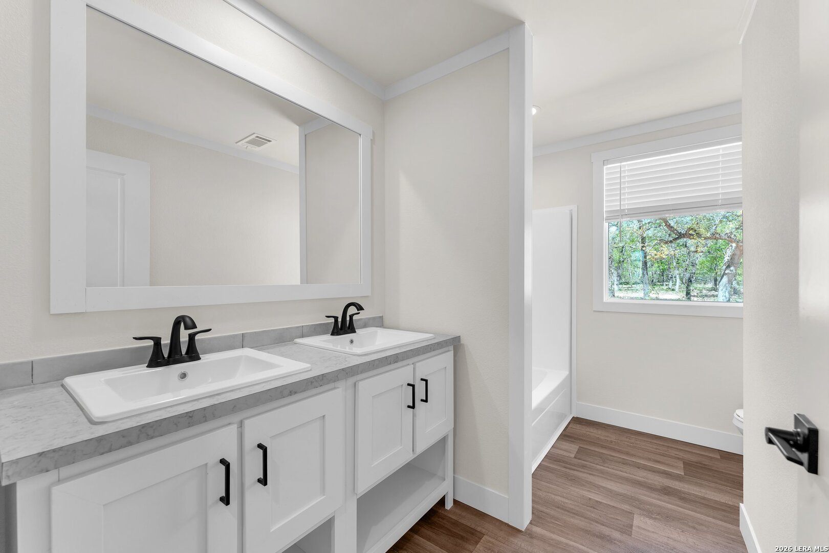 2218 Stevens Road Somerset, TX 78069 - Photo 21 of 24 a bathroom with a sink and a mirror