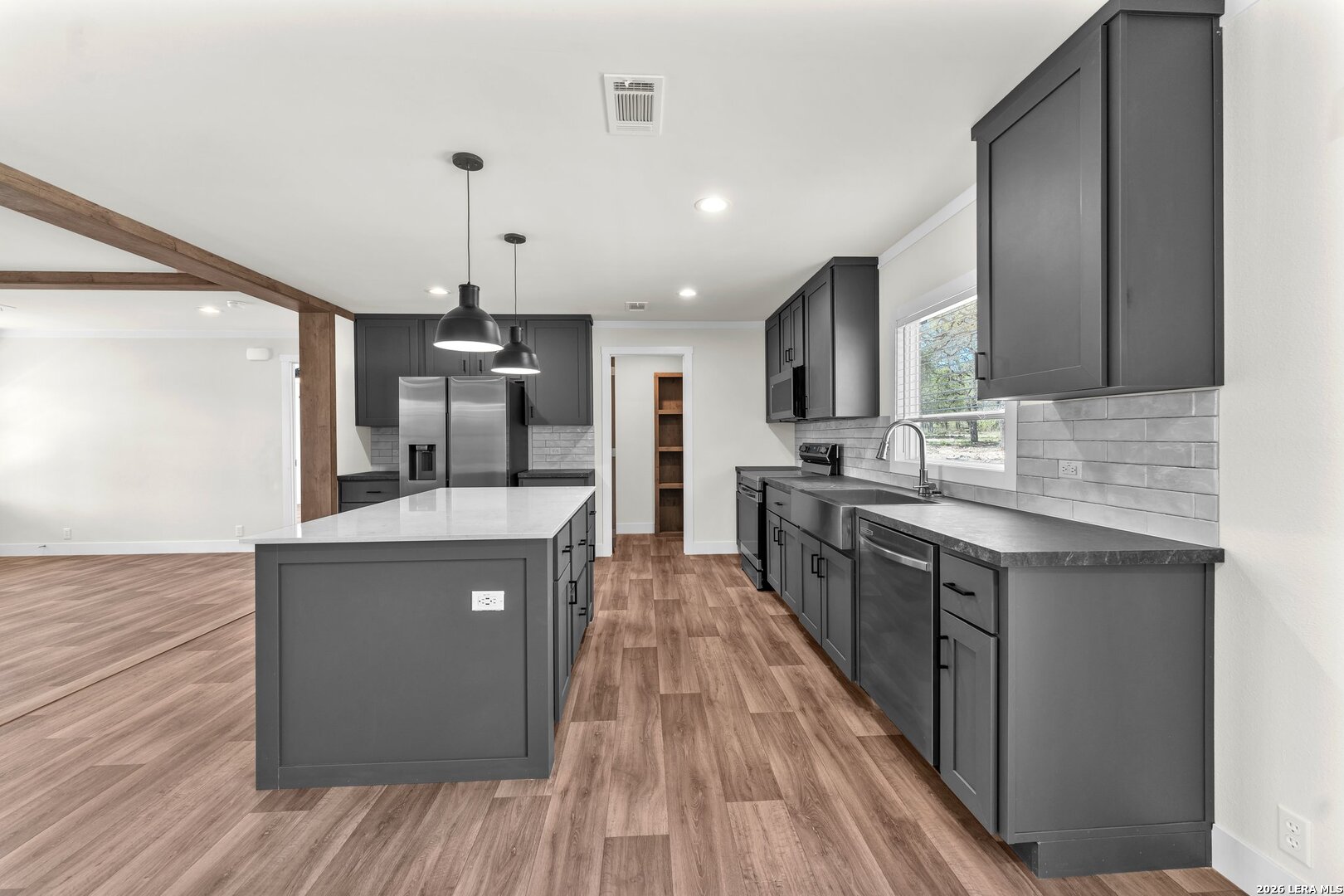 2218 Stevens Road Somerset, TX 78069 - Photo 7 of 24 a kitchen with stainless steel appliances granite countertop a stove and cabinets