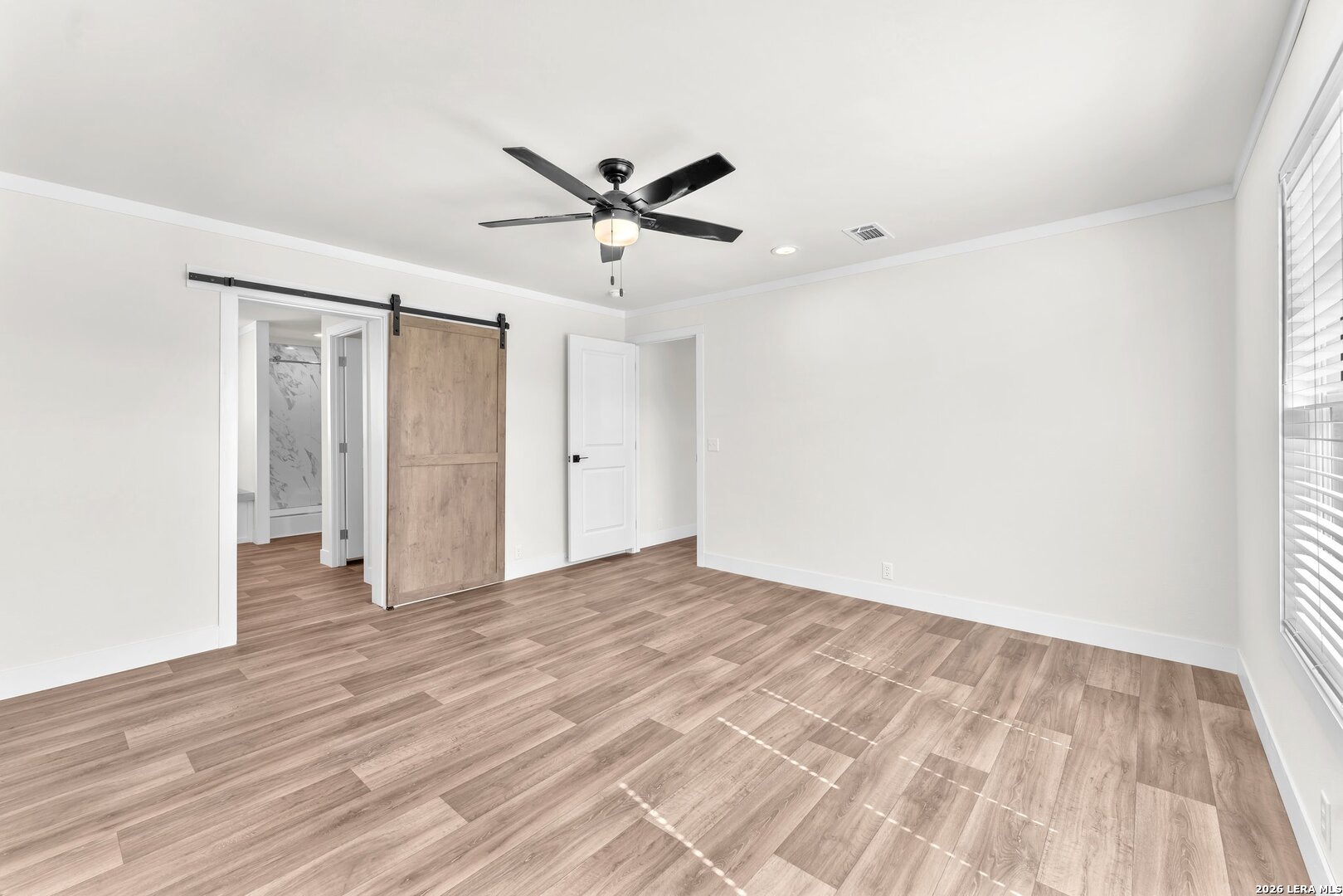 2218 Stevens Road Somerset, TX 78069 - Photo 10 of 24 a view of empty room with wooden floor and fan