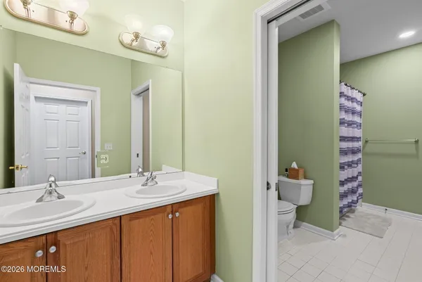 a bathroom with a sink a toilet and mirror