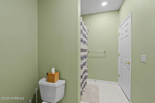 a bathroom with a toilet and shower