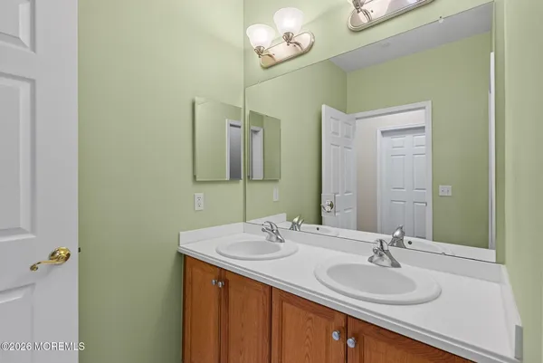 a bathroom with a sink a mirror and a light fixture