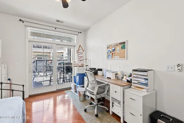 a view of a workspace with furniture and a window