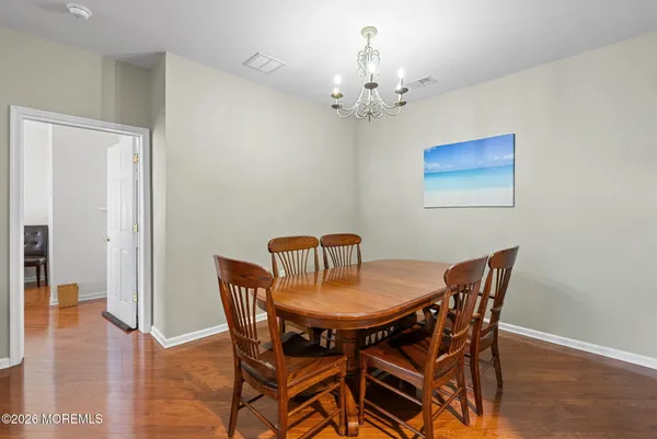 a view of a dining room with furniture and chandelier