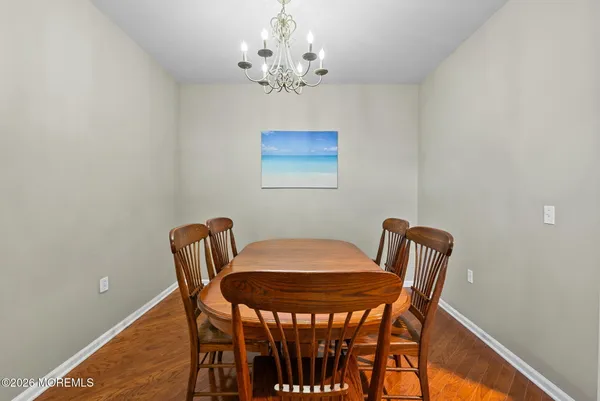 a view of a dining room with furniture and chandelier