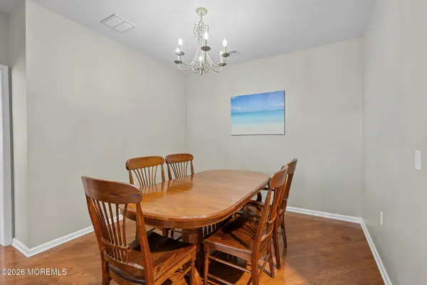 a view of a dining room with furniture and chandelier