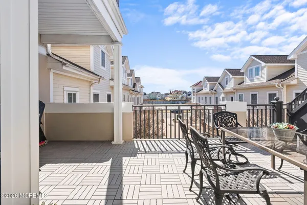 a view of a brick house with a dinning table and chairs