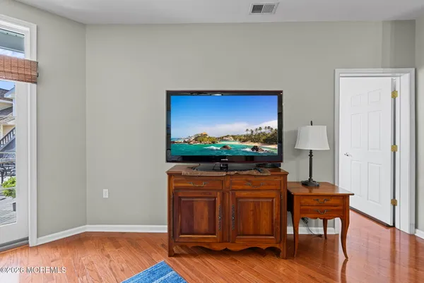 a living room with chair and a flat screen tv