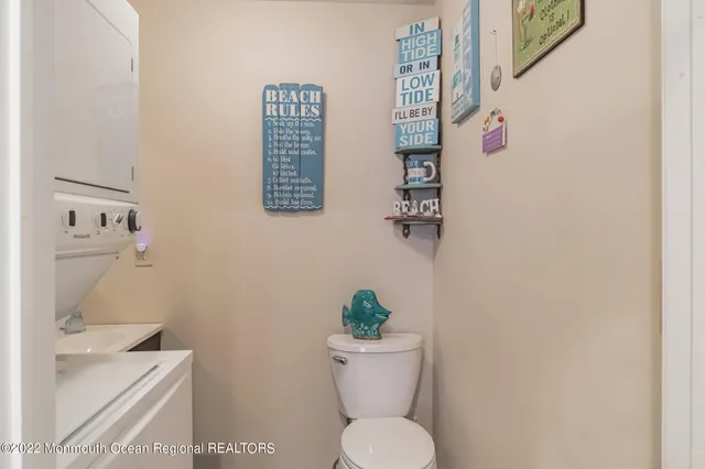 a white toilet sitting next to a bathroom sink