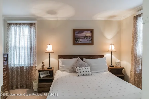 a bedroom with a bed and a lamp