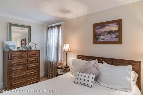 a bedroom with a bed and cabinet