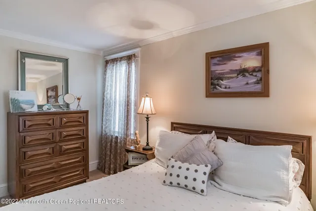 a bedroom with a bed and cabinet