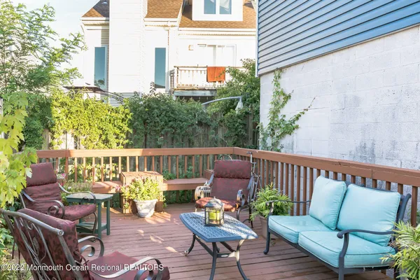 a balcony with wooden benches and couch