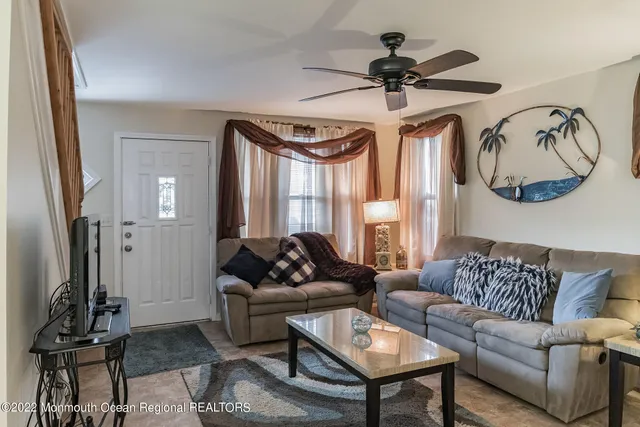 a living room with furniture a window and a chandelier