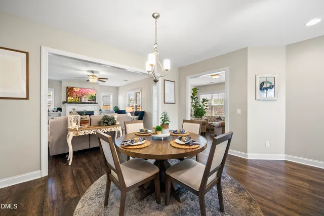 a view of a dining room with furniture a rug and wooden floor