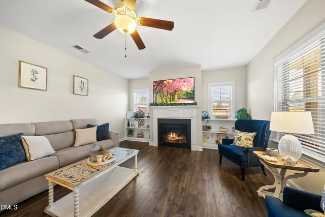 a living room with furniture potted plant and a window