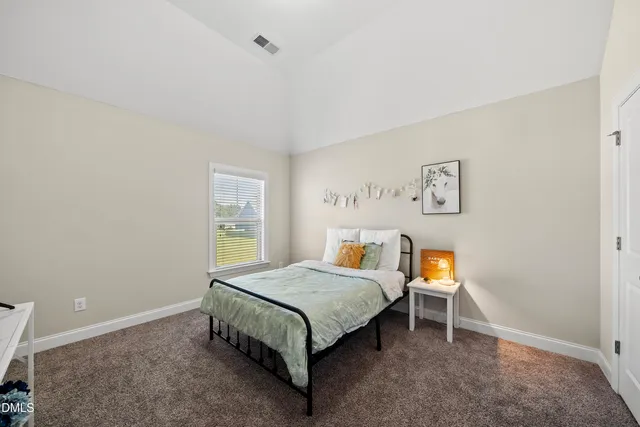 a bedroom with a bed and a desk