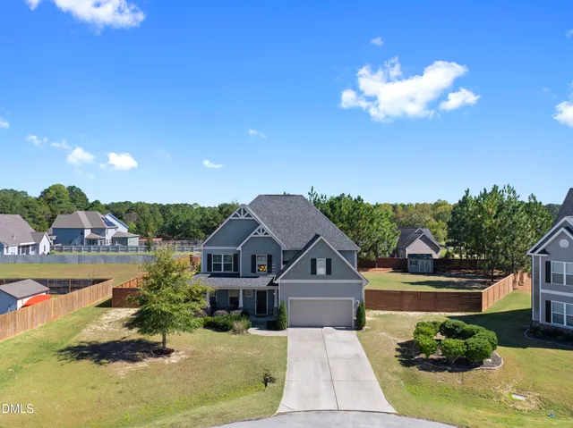 a view of a house with swimming pool and furniture