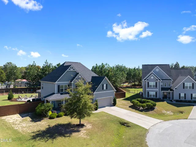 a view of house with yard and swimming pool