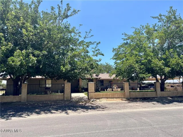 a view of a house with a tree in front
