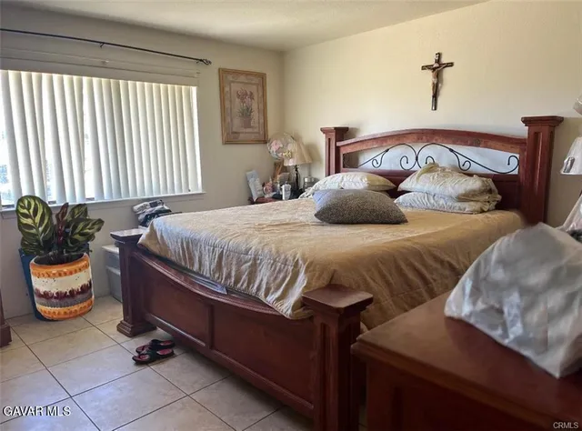 a bedroom with a bed and window