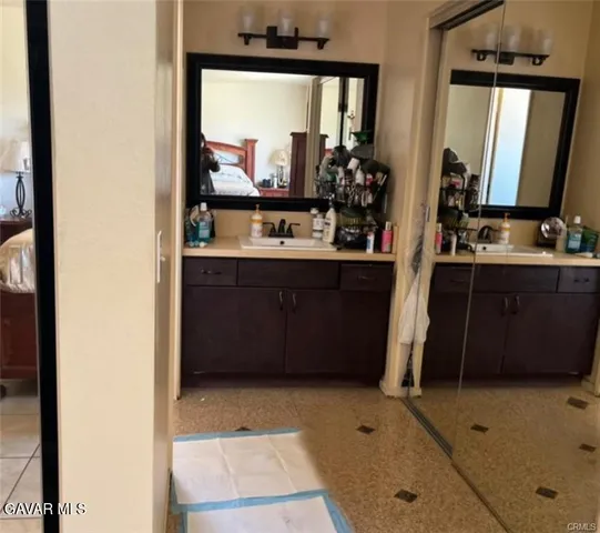 a bathroom with a sink a mirror and a bathtub