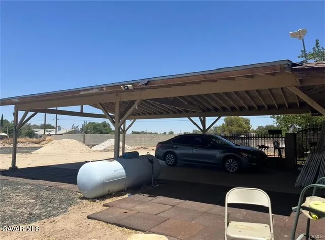 a backyard of a house with table and chairs