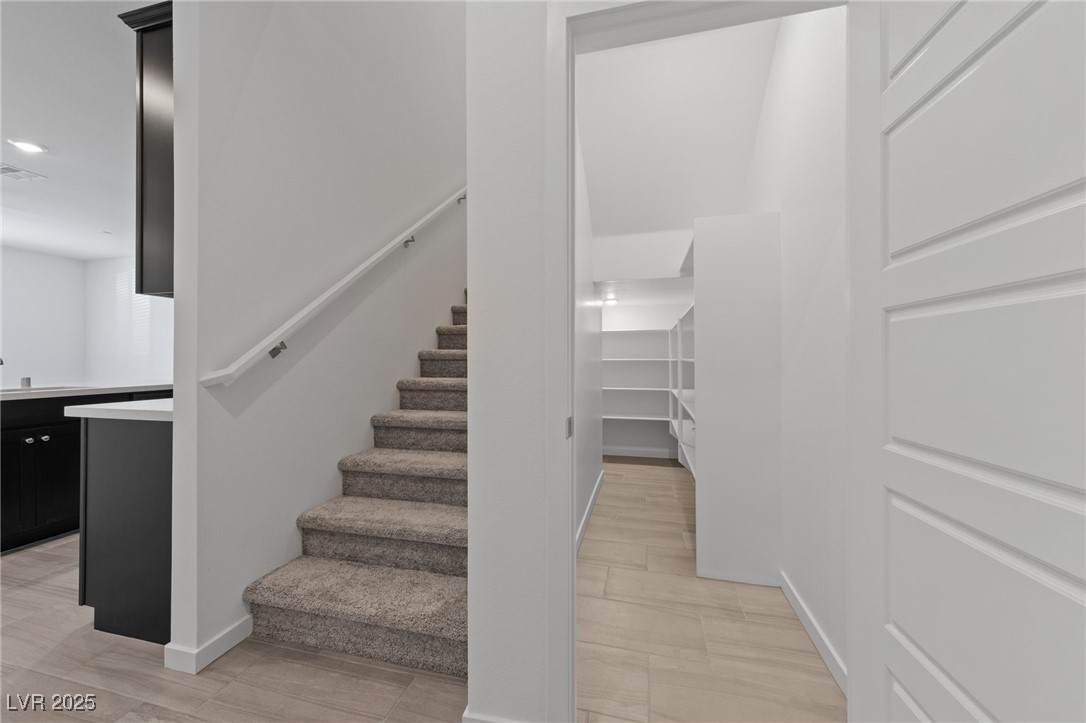 1561 Layla Crossing Avenue Henderson, NV 89002 - Photo 13 of 31 Staircase featuring wood finished floors and baseboards