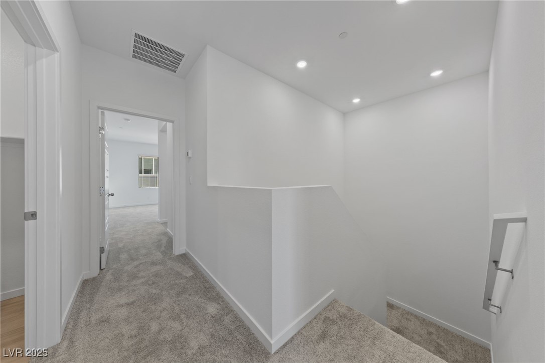 1561 Layla Crossing Avenue Henderson, NV 89002 - Photo 14 of 31 Hall featuring an upstairs landing, light colored carpet, and recessed lighting